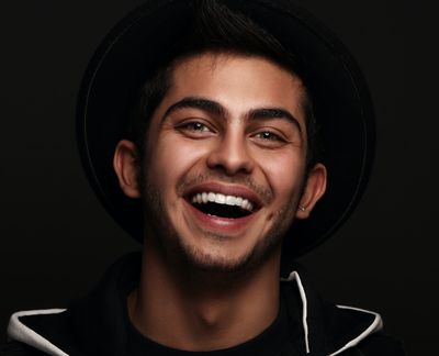 Person wearing a black hat and smiling